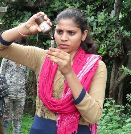 Student testing water for fluoride levels in India